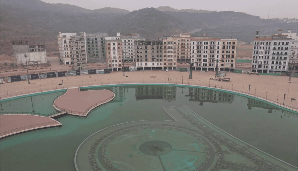 Imtiaz Marketing residential complex with a central water fountain and surrounding apartment buildin.