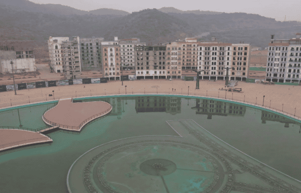 Imtiaz Marketing residential complex with a central water fountain and surrounding apartment buildin.